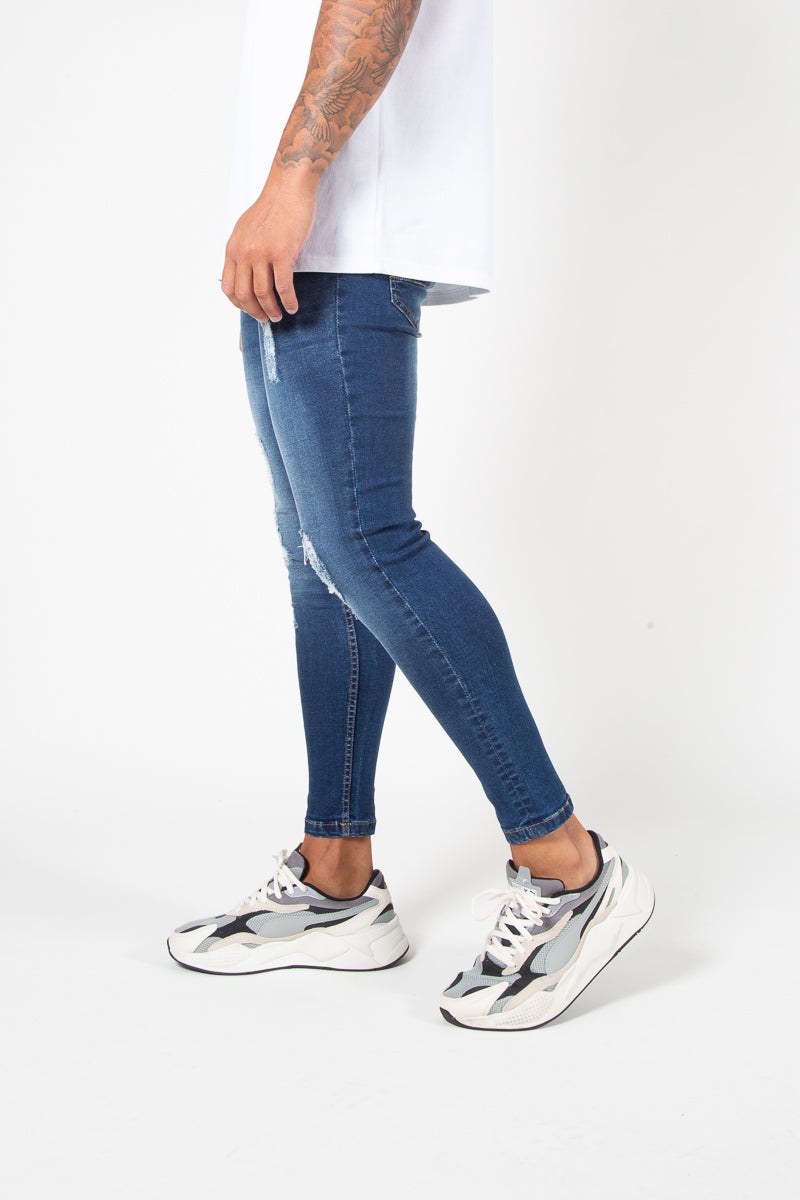 ASOS DESIGN super skinny jeans in mid wash blue with abrasions